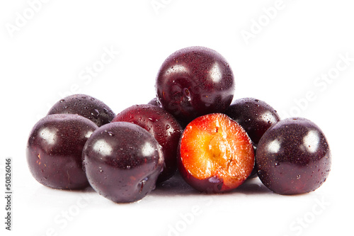 Photo: Red plum fruit isolated on white background. Fresh ripe washed Red plum fruit isolated on white background. Fresh ripe washed