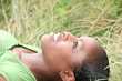 African woman lying on grass