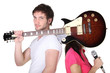 Young couple with a guitar and microphone