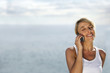 Woman on telephone at the beach
