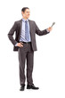 Full length portrait of a professional male reporter holding a m