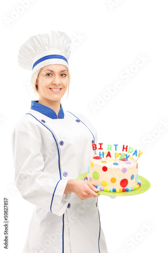 Photo: Female chef holding a birthday cake Female chef holding a birthday cake