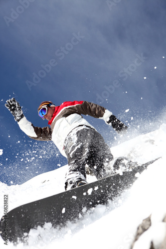 Photo: Snowboarder spraying powder Snowboarder spraying powder