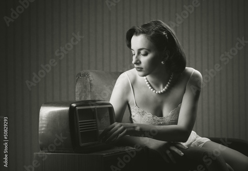 Photo: Sensual woman listening music on old radio Sensual woman listening music on old radio