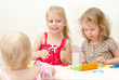 Llittle girls sculpting using plasticine
