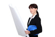 Female architect examining plans