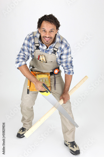 Photo: Carpenter sawing lath Carpenter sawing lath
