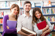 Smiling students in a library