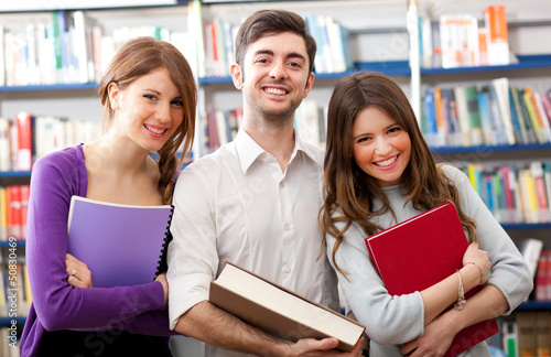 Photo: Smiling students in a library Smiling students in a library