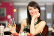 Woman toasting wine in a restaurant