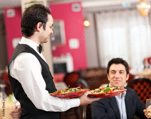 Photo: Waiter serving in a restaurant Waiter serving in a restaurant