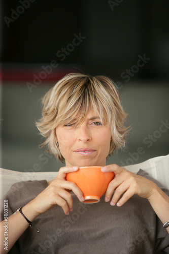 Photo: woman drinking tea on the sofa woman drinking tea on the sofa