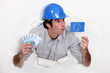 craftsman holding european flag and bank notes