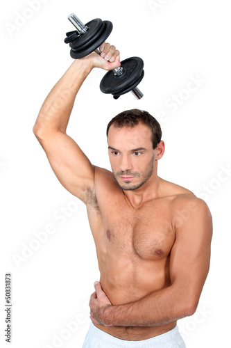 Photo: bare-chested man muscular man doing fitness with dumbbell bare-chested man muscular man doing fitness with dumbbell