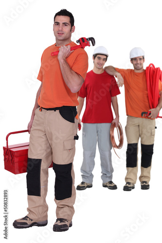 Photo: Three plumbers ready to work Three plumbers ready to work