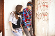 Young hipster guy with his girlfriend sitting in the shadow