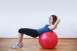 Photo: Young woman exercise with ball in the gym. Young woman exercise with ball in the gym.