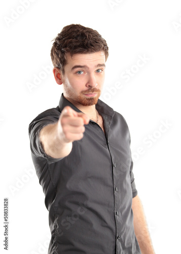 Photo: Portrait of smiling handsome man pointing at you over white Portrait of smiling handsome man pointing at you over white