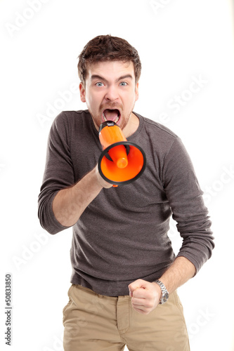 Photo: Young man shouting through megaphone Young man shouting through megaphone