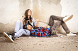 Young hipster guy with his girlfriend sitting in the shadow