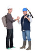 apprentice and senior bricklayer isolated on white