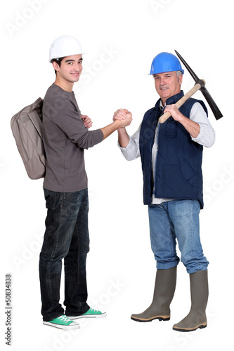 Photo: apprentice and senior bricklayer isolated on white apprentice and senior bricklayer isolated on white