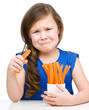 Cute little girl is eating carrot