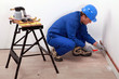 Plumber fitting copper pipes to a wall