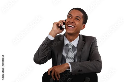 Photo: Businessman laughing on the phone Businessman laughing on the phone