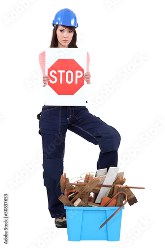 Photo: girl with safety helmet holding stop sign girl with safety helmet holding stop sign