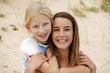 Photo: Mother and daughter sat on sand dune Mother and daughter sat on sand dune