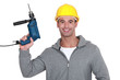 A construction worker holding a drill.