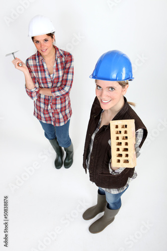 Photo: Women with trowel and brick Women with trowel and brick
