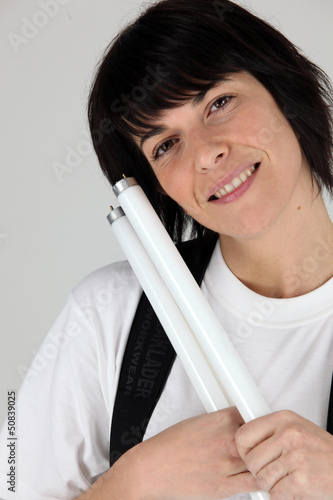 Photo: Electrician holding replacement tube bulbs Electrician holding replacement tube bulbs