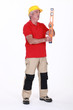 Middle-aged manual worker holding spirit-level
