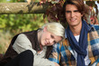 Photo: Attractive couple sat by fence Attractive couple sat by fence