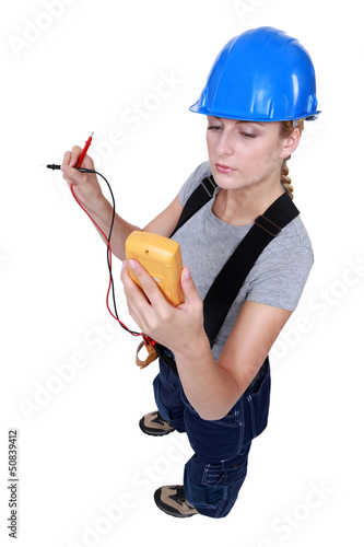 Photo: Woman taking electrical reading Woman taking electrical reading