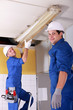 Electricians installing neon lights in the ceiling