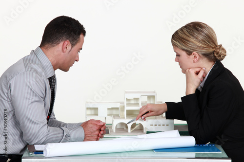 Photo: Architects evaluating a building model Architects evaluating a building model