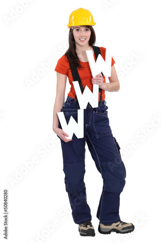 Photo: Woman wearing a helmet and holding letters Woman wearing a helmet and holding letters