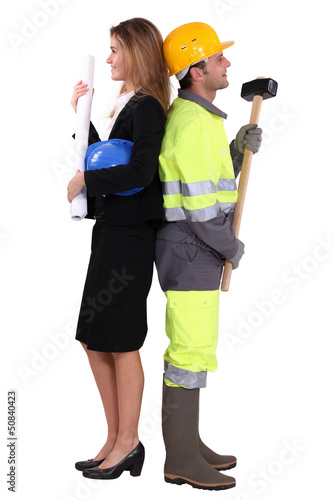 Photo: businesswoman and craftsman standing back to back businesswoman and craftsman standing back to back
