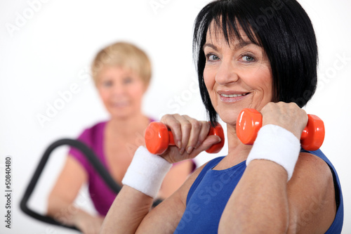 Photo: Two women working out in the gym Two women working out in the gym
