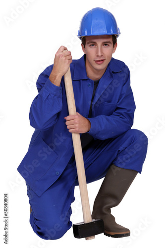Photo: Labourer holding a mallet Labourer holding a mallet