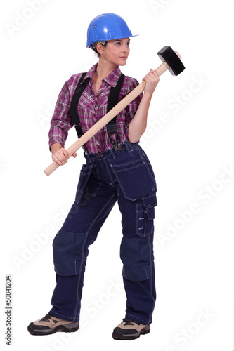 Photo: Female construction worker holding a rubber mallet Female construction worker holding a rubber mallet