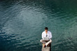 Businessman sat by lake