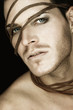 Portrait of a beautiful young man with strip of leather