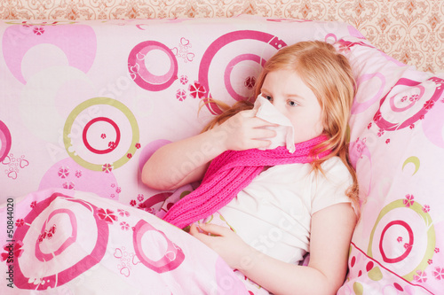 Photo: girl is blowing her nose girl is blowing her nose