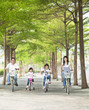 happy family riding bicycle in the park