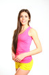 Attractive fitness girl posing on a white background