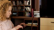 pretty student working with laptop in home - tracking shot
